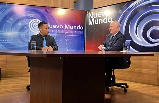 Two Reporters Sitting In Front