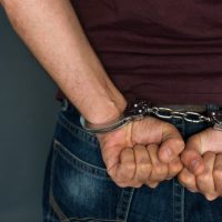 Caucasian male arrested and with handcuffs