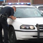 Policeman writing up report Policeman writing up report